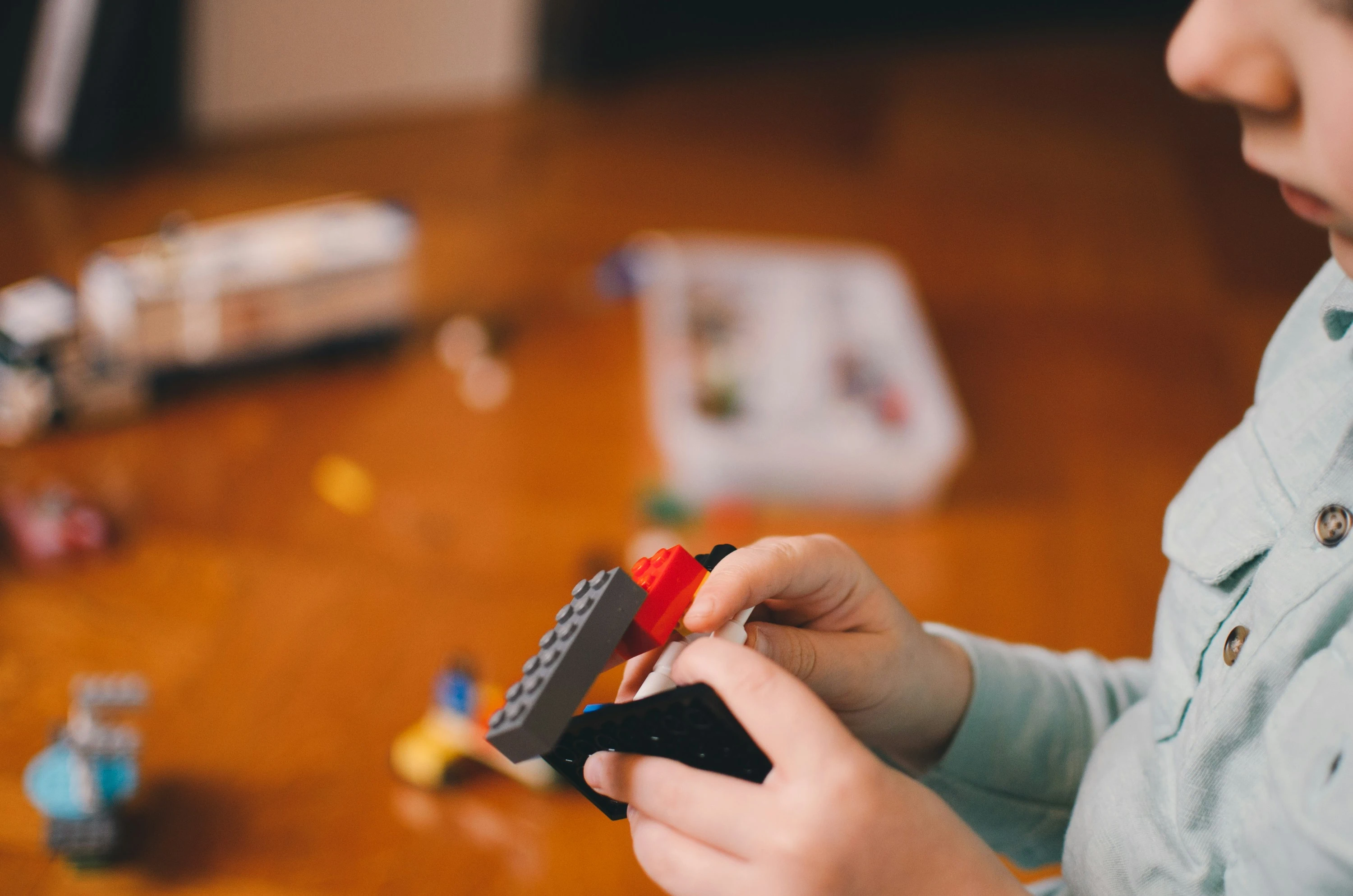 A child happily building with Lego — engaged, focused play